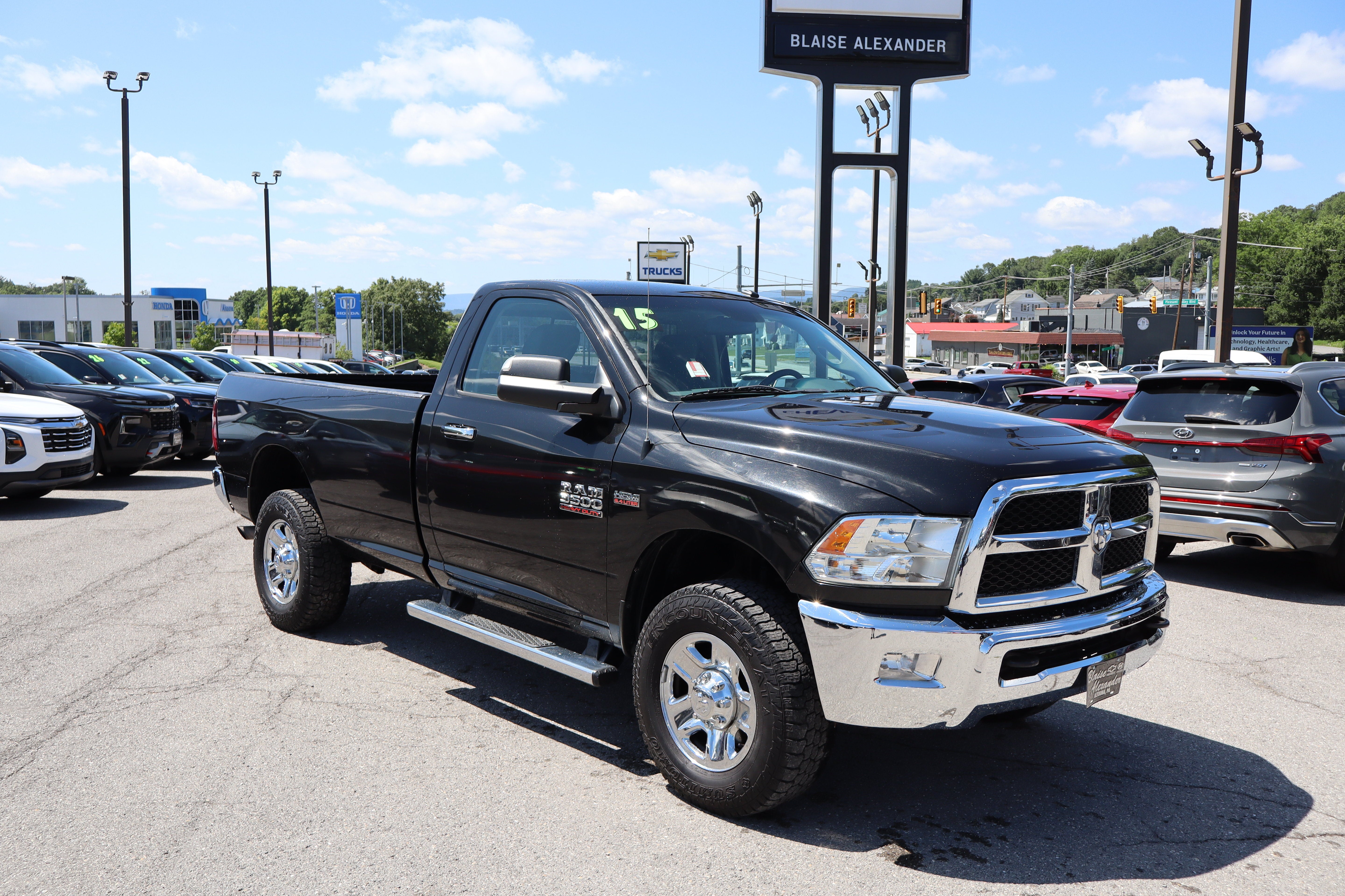 2015 RAM 3500 SLT in Brilliant Black Crystal Pearlcoat — front three-quarter view